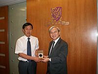 Prof. P.W. Liu (right), Pro-Vice-Chancellor presents a souvenir to Prof. Zhang Shaojie (left), Vice-President of Northeast Normal University
